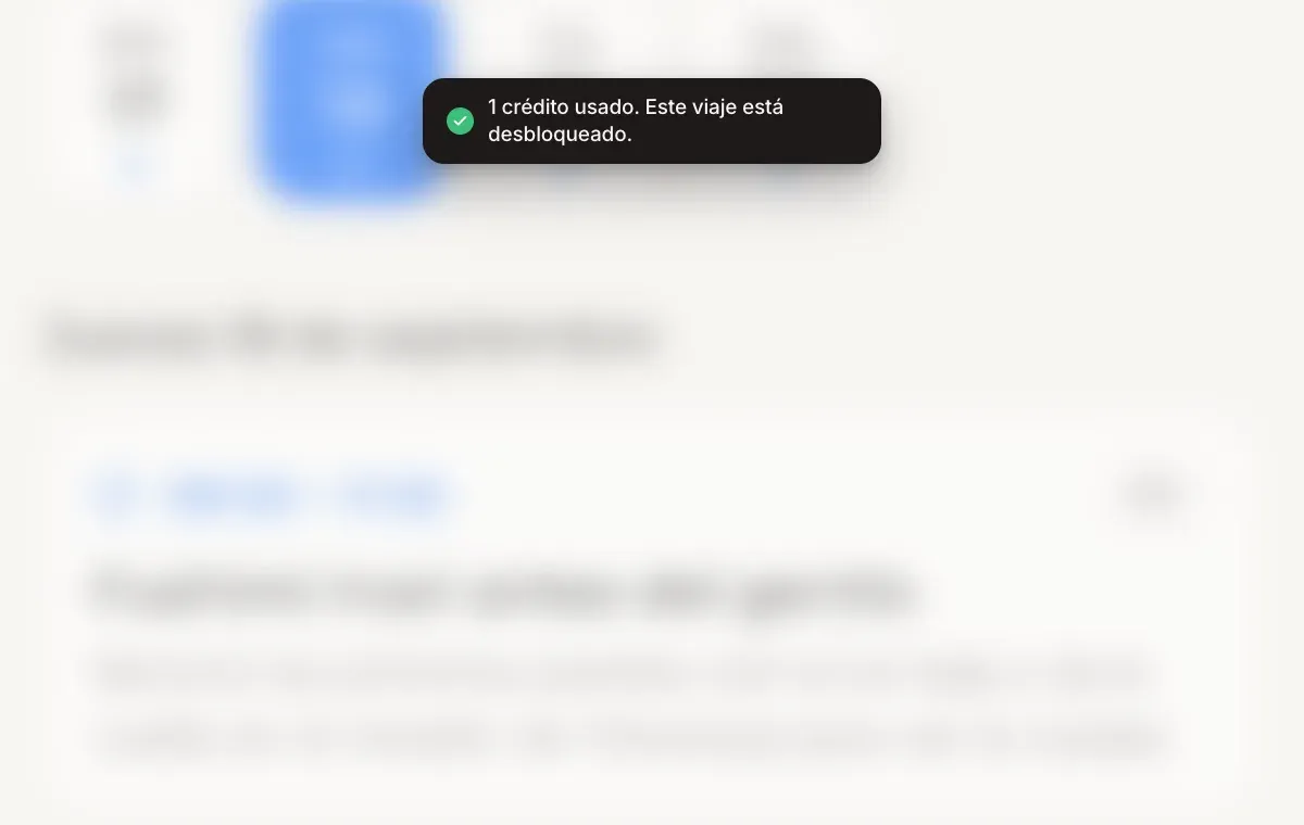 Un aviso con el texto "1 crédito usado. Este viaje está desbloqueado." sobre un itinerario de viaje.