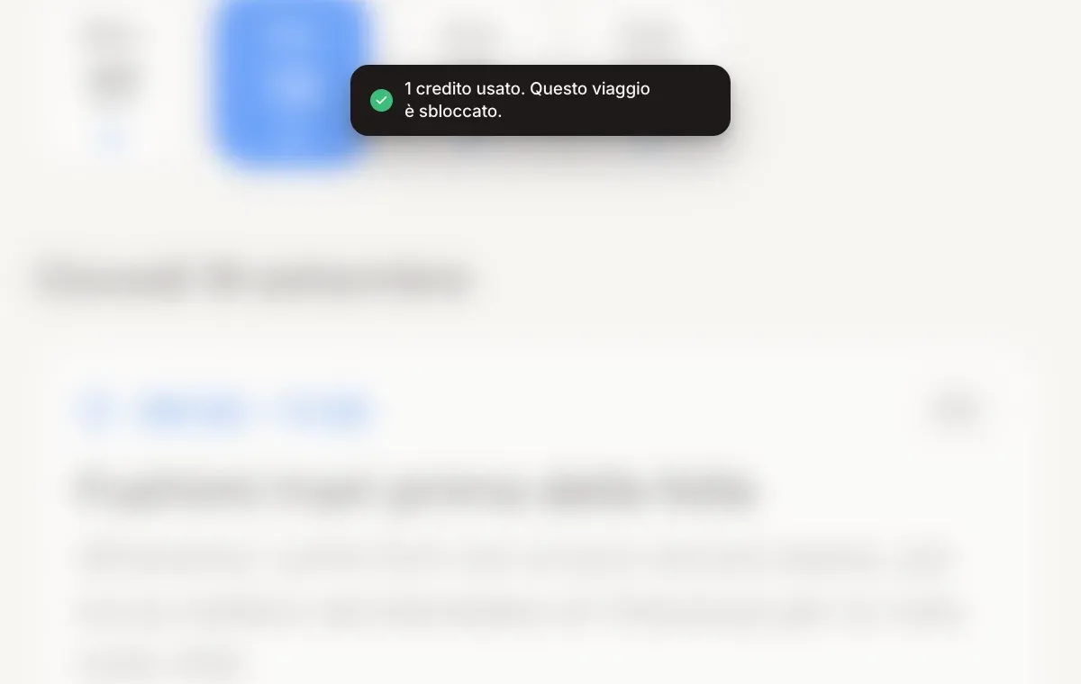 Un avviso con il testo "1 credito usato. Questo viaggio è sbloccato." sopra un itinerario di viaggio.